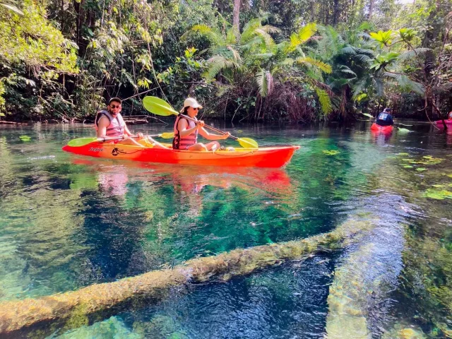 Visitors in a red kayak on Klong Root’s clear spring-fed water