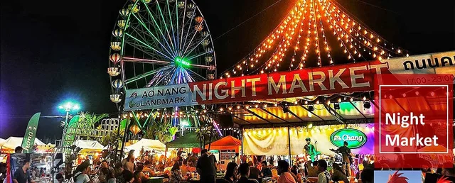 Crowds beneath the illuminated Ao Nang Landmark Night Market entrance at night.